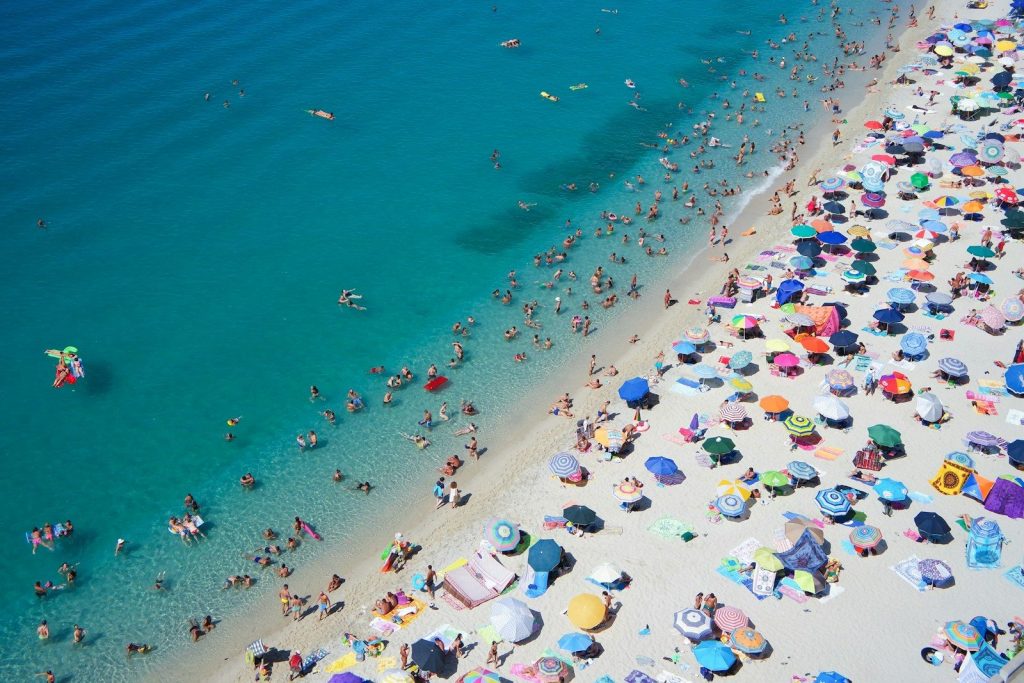 group of people swimming on beach